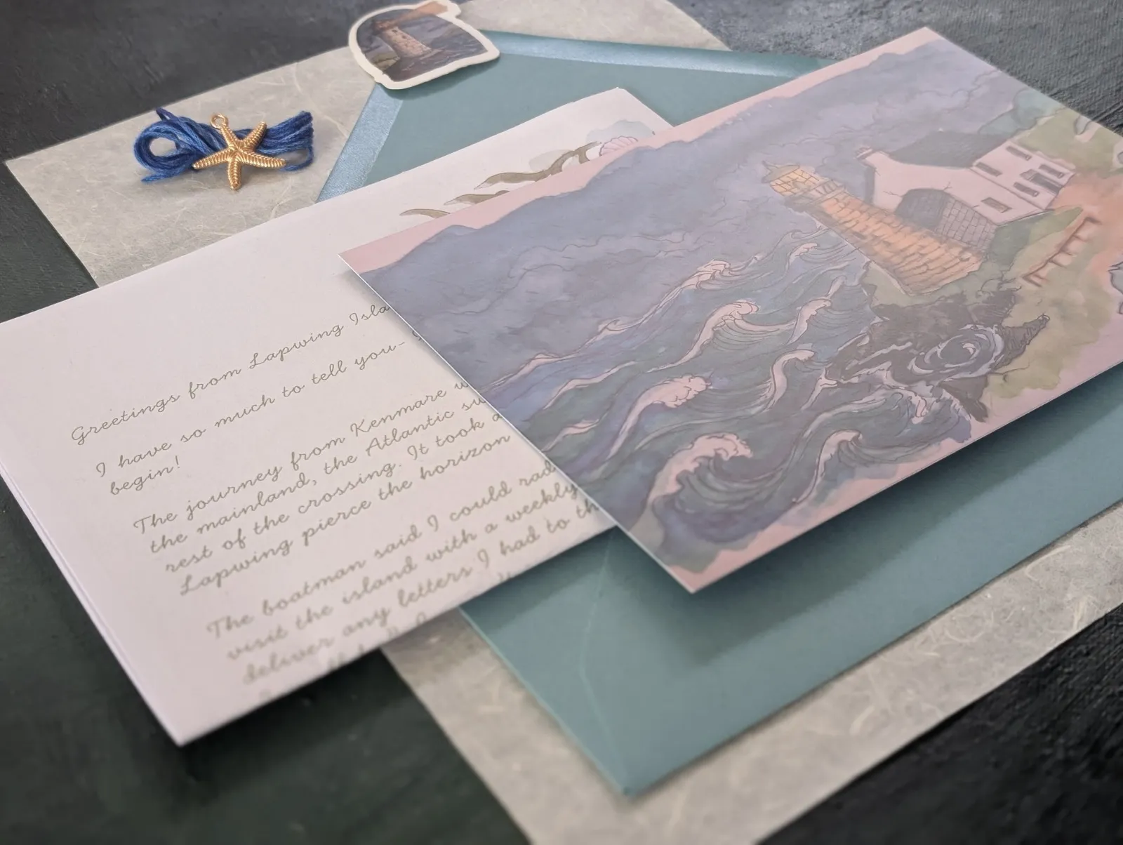 A handwritten letter, a watercolour postcard of a lighthouse, a teal envelope and a starfish charm: one installment of The Keeper.
